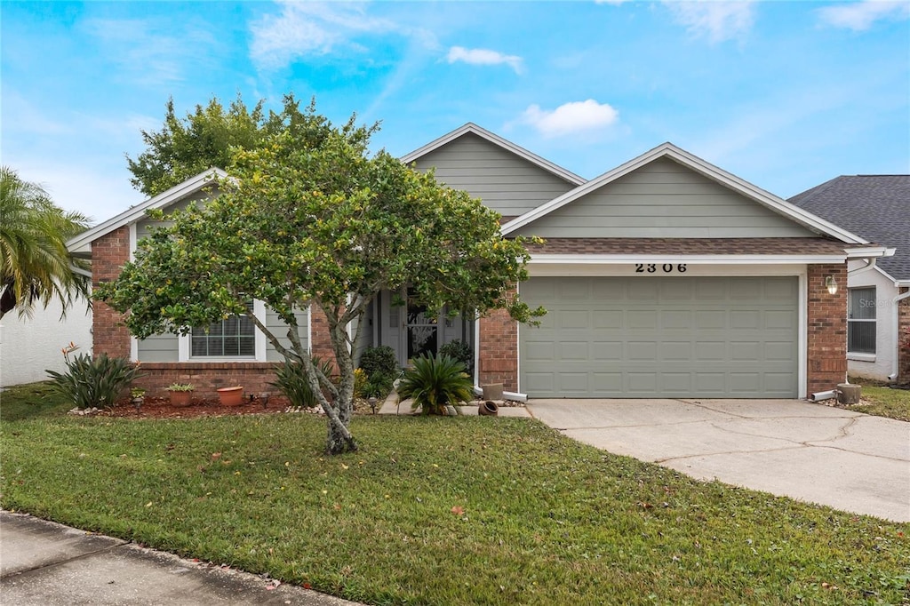 view of front of house with a garage and a front yard