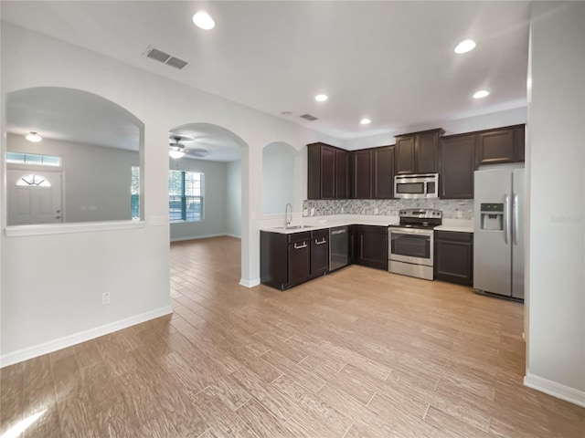 kitchen featuring sink, dark brown cabinets, decorative backsplash, and stainless steel appliances