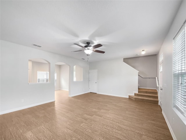 unfurnished living room with light hardwood / wood-style floors and ceiling fan