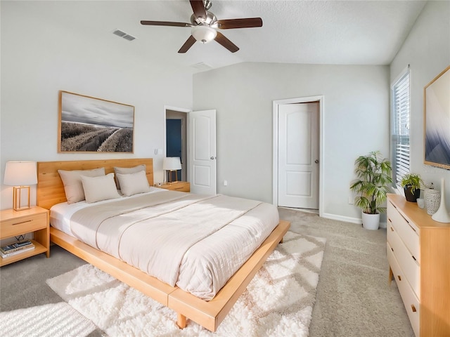 bedroom featuring ceiling fan, vaulted ceiling, and light carpet