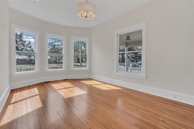 unfurnished dining area featuring hardwood / wood-style floors