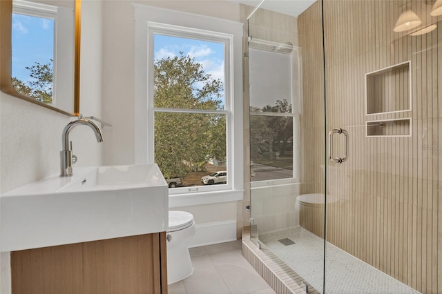 bathroom featuring sink, toilet, an enclosed shower, and tile patterned flooring