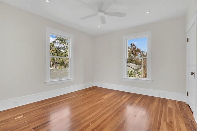 unfurnished room with ceiling fan and hardwood / wood-style floors