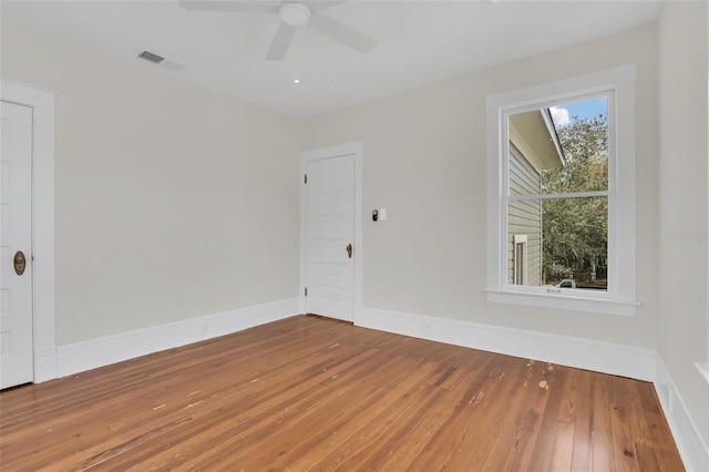 empty room with hardwood / wood-style flooring and ceiling fan