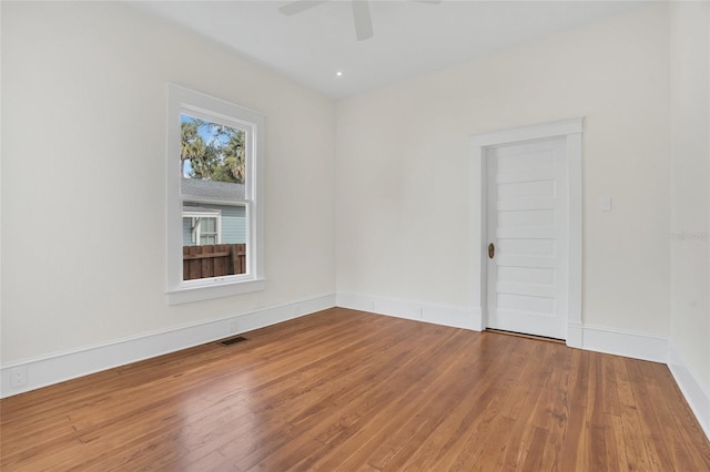 spare room featuring hardwood / wood-style flooring and ceiling fan