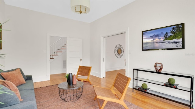 219 Laurel Ave, Sanford, FL 32771 - living area with stairs, wood finished floors, and baseboards