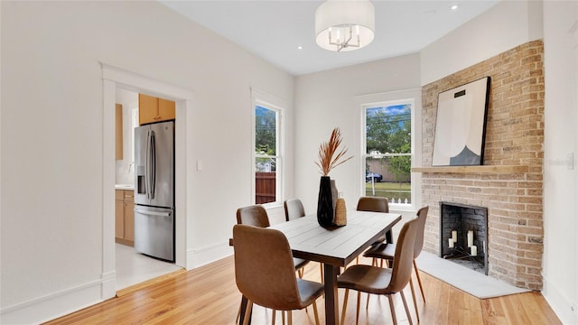 219 Laurel Ave, Sanford, FL 32771 - dining space with light wood-style floors, a fireplace, and baseboards
