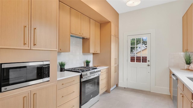 219 Laurel Ave, Sanford, FL 32771 - kitchen featuring stainless steel appliances, light brown cabinetry, and light countertops