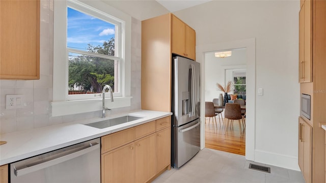 219 Laurel Ave, Sanford, FL 32771 - kitchen featuring stainless steel appliances, a sink, light countertops, and healthy amount of natural light