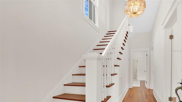 219 Laurel Ave, Sanford, FL 32771 - staircase with wood finished floors, a chandelier, a high ceiling, and baseboards
