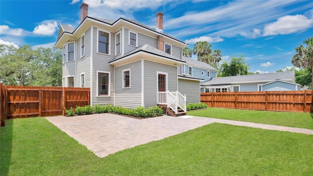 219 Laurel Ave, Sanford, FL 32771 - back of property with a chimney and a patio area