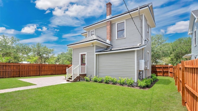 219 Laurel Ave, Sanford, FL 32771 - back of property featuring a chimney, entry steps, a patio area, and roof with shingles