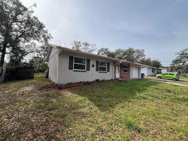 view of front of house featuring a front lawn and a garage