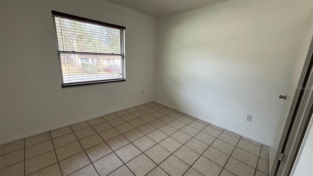 tiled empty room with a wealth of natural light