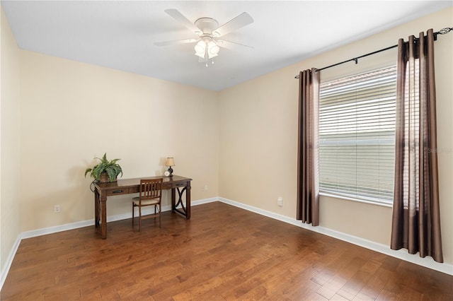 home office featuring dark wood-type flooring and ceiling fan