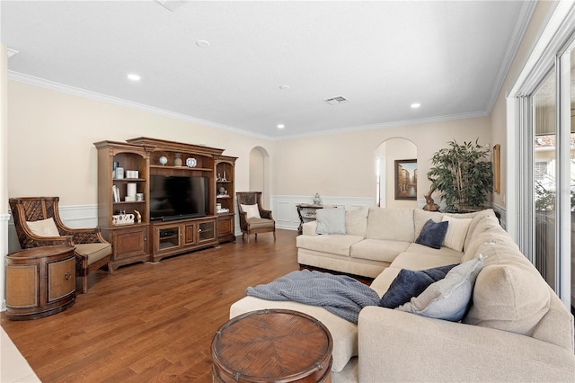 living room with wood-type flooring and ornamental molding