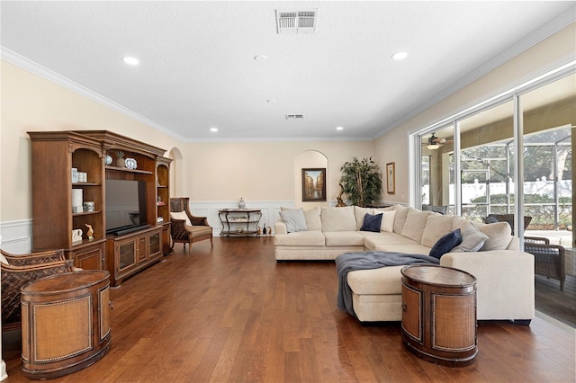 living room featuring crown molding and dark wood-type flooring