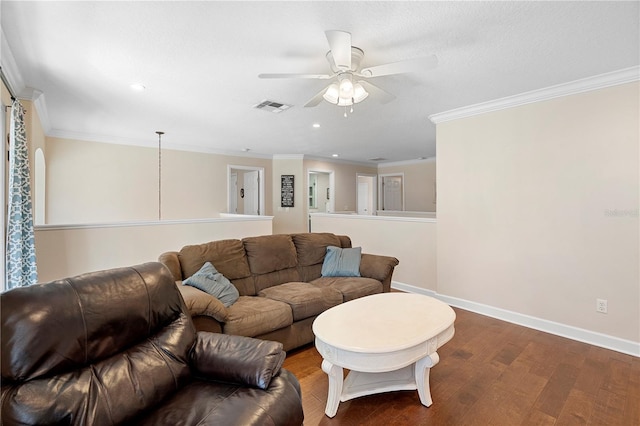 living room featuring wood-type flooring, ornamental molding, and ceiling fan