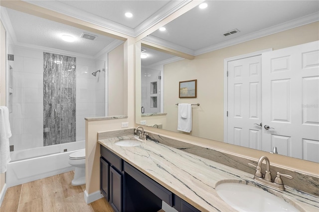 full bathroom featuring crown molding, wood-type flooring, toilet, and vanity