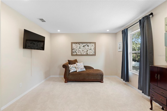 sitting room with light colored carpet