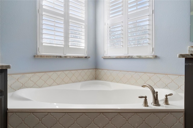 bathroom featuring vanity and a bath