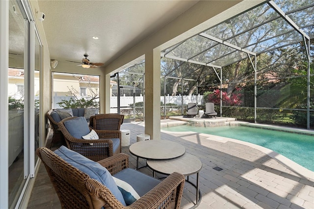 view of pool featuring ceiling fan, a lanai, and a patio