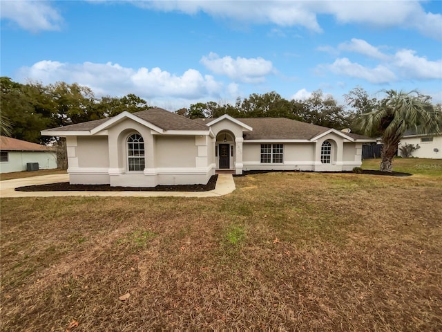 single story home with central air condition unit and a front yard