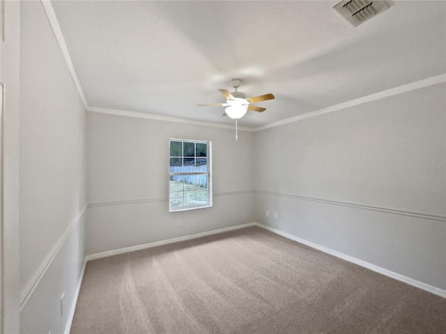 carpeted spare room featuring ceiling fan and crown molding