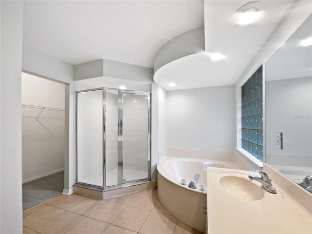 bathroom featuring vanity, shower with separate bathtub, and tile patterned flooring