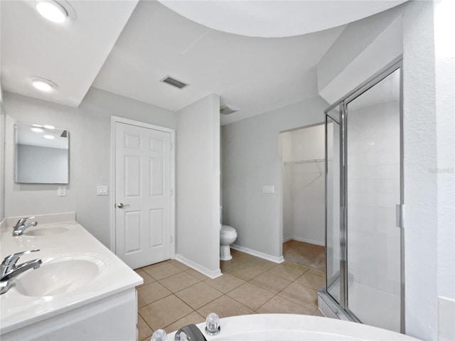 bathroom with vanity, toilet, tile patterned floors, and an enclosed shower