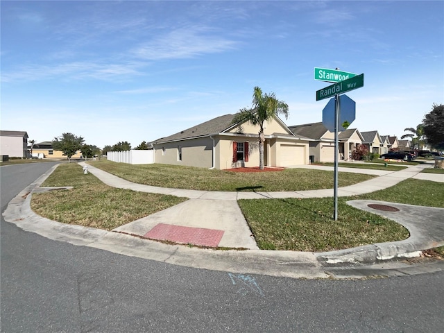 ranch-style home with a garage and a front yard