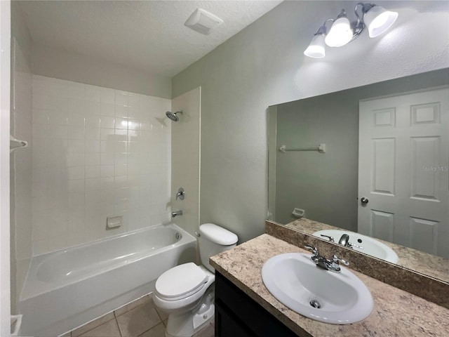 full bathroom featuring toilet, a textured ceiling, tiled shower / bath combo, tile patterned flooring, and vanity