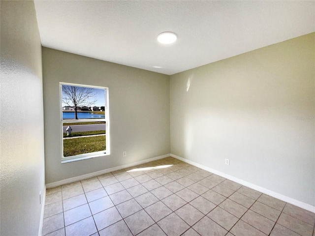 unfurnished room featuring light tile patterned flooring