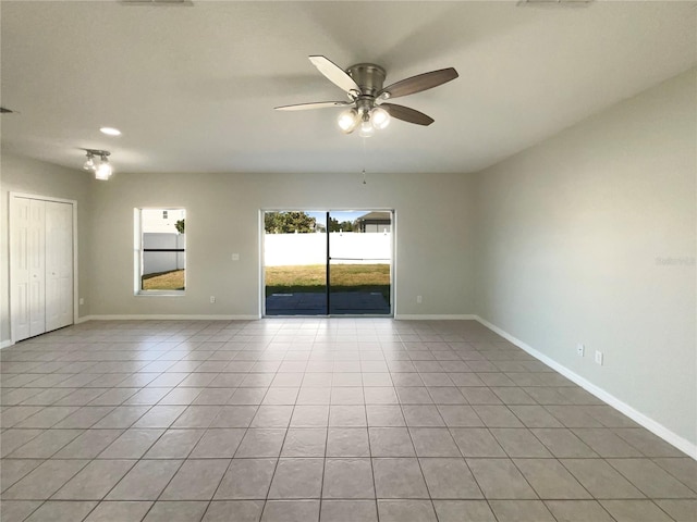 tiled empty room with ceiling fan