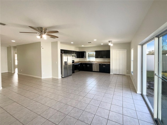 kitchen with light tile patterned floors, sink, appliances with stainless steel finishes, and ceiling fan