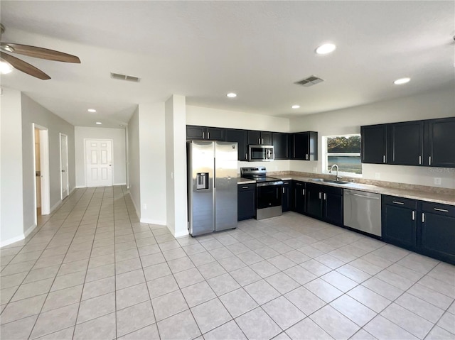 kitchen featuring sink, light tile patterned floors, ceiling fan, and stainless steel appliances