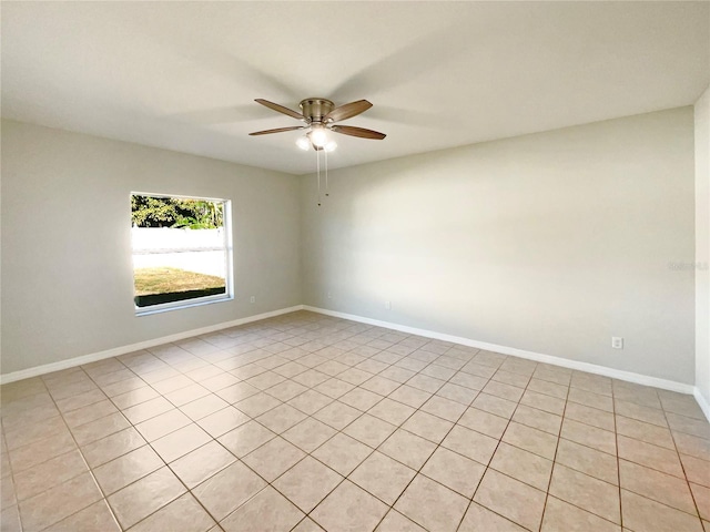 empty room with ceiling fan and light tile patterned flooring