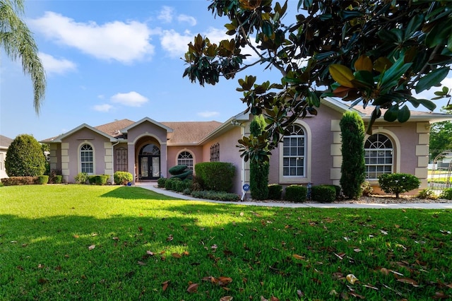 ranch-style house with french doors and a front yard