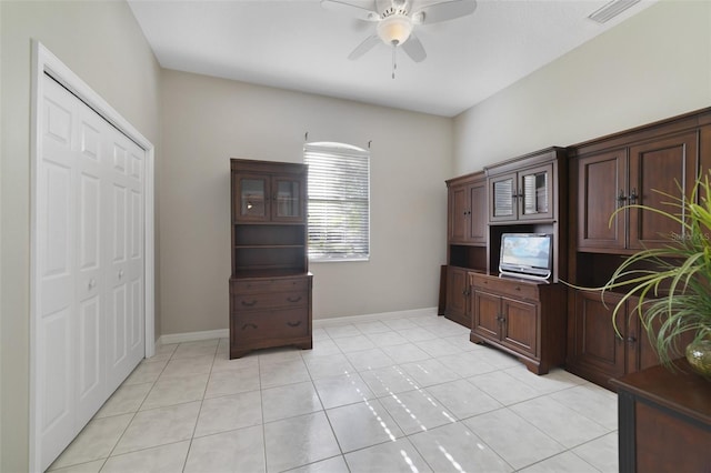 office space with ceiling fan and light tile patterned floors