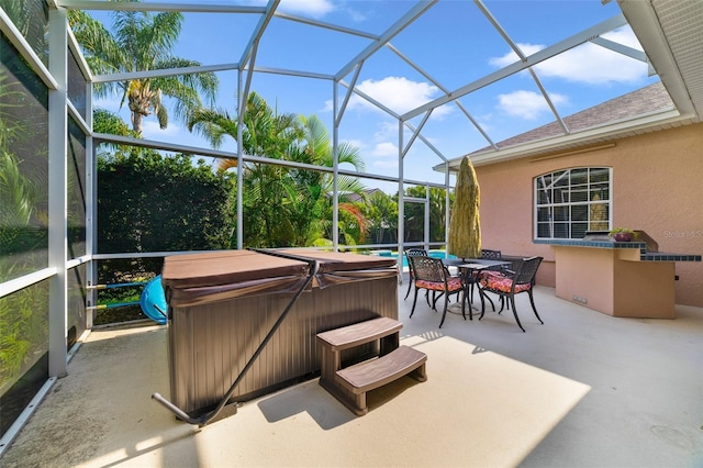 view of patio / terrace with a lanai and a hot tub