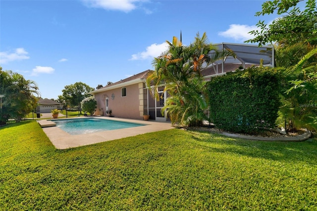 view of pool with a patio area, a lanai, and a yard