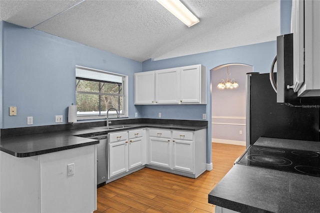 kitchen with sink, light hardwood / wood-style flooring, appliances with stainless steel finishes, white cabinetry, and a textured ceiling