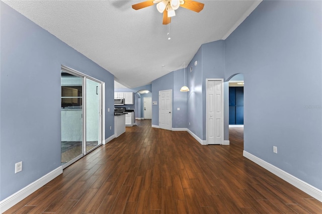 unfurnished living room with dark hardwood / wood-style flooring, high vaulted ceiling, ceiling fan, and a textured ceiling