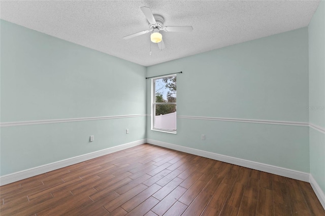 empty room with dark hardwood / wood-style flooring, a textured ceiling, and ceiling fan