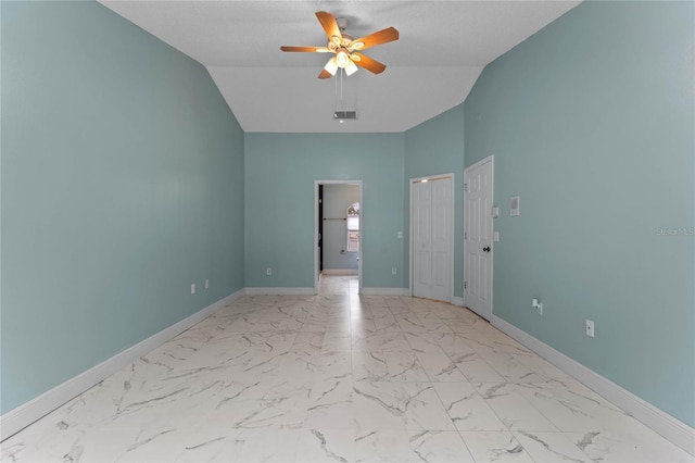 empty room with ceiling fan and lofted ceiling