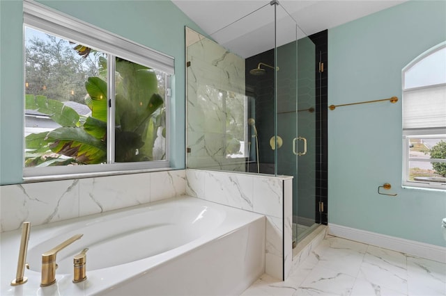 bathroom with lofted ceiling, a wealth of natural light, and plus walk in shower