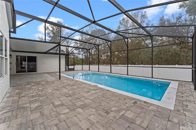 view of pool with a patio and glass enclosure