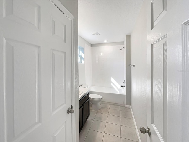 full bathroom featuring toilet, tiled shower / bath combo, vanity, and tile patterned floors