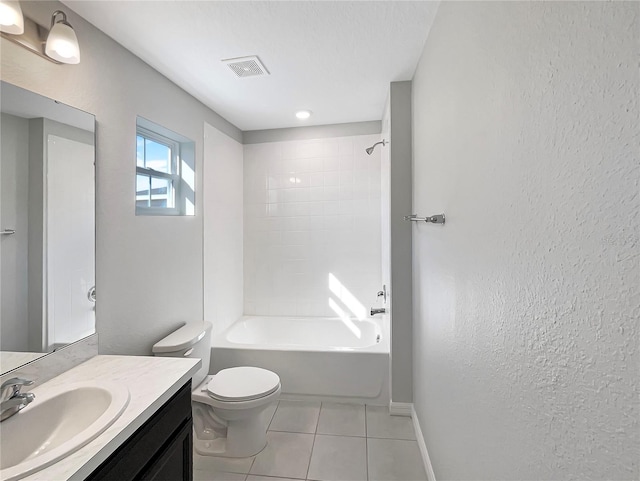 full bathroom featuring toilet, vanity, tile patterned floors, and tiled shower / bath