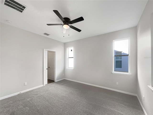 spare room featuring ceiling fan and carpet